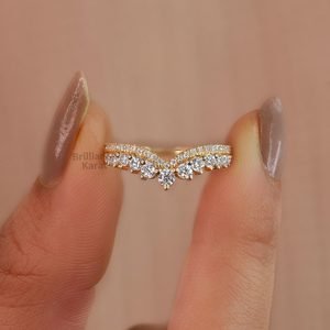 gold ring in between two fingers